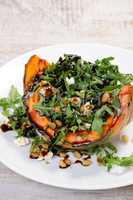 wedge baked of pumpkin with arugula and cheese