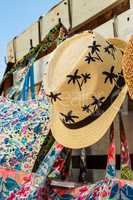 Straw hat with drawings of palm trees.
