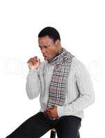 Coughing young man sitting with scarf