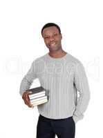 African man standing with books under his arms