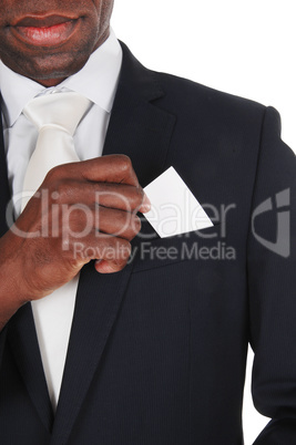 Black man putting business card in pocket