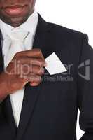 Black man putting business card in pocket