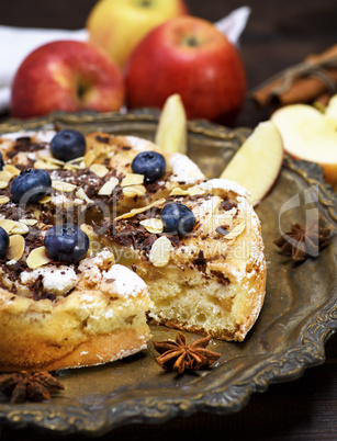 baked pie with apples on an iron plate