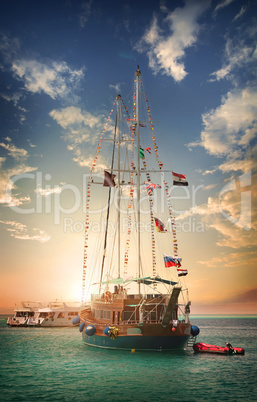 Wooden sailboat at sunset
