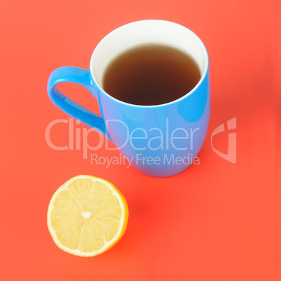 Blue cup with tea on a red background. Flat lay,top view.