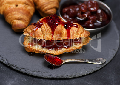 baked croissant with strawberry jam