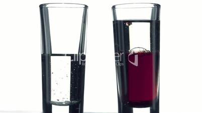 Filling a glass of color liquid on white background. Healthy and fresh water