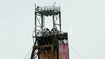 Industrial mine billowing smoke into blue skies