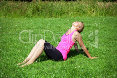 woman sitting on green grass