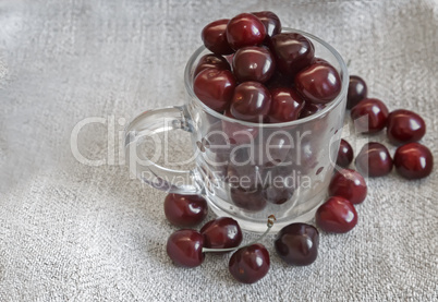 Glass Cup with cherries on the table.