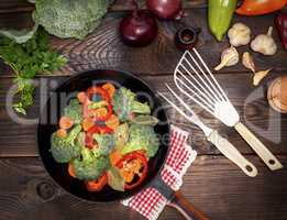 fresh vegetables in a black round frying pan