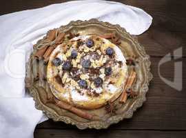 round baked pie with apples and blueberries