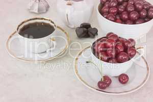 Coffee and cherries in a Cup on the table.