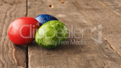 Colored Easter eggs on wood