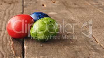 Colored Easter eggs on wood
