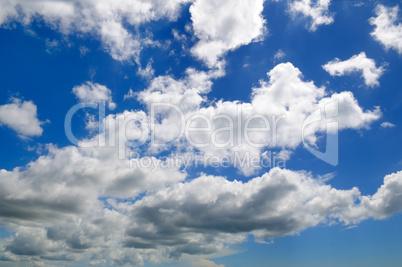 Cumulus clouds in the blue sky.