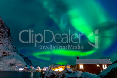 Northern Lights above the Snow-Covered Houses