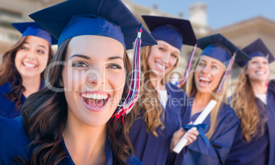 Happy Graduating Group of Girls In Cap and Gown Celebrating on C