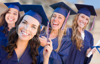 Happy Graduating Group of Girls In Cap and Gown Celebrating on C