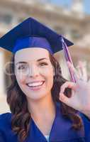 Happy Graduating Mixed Race Woman In Cap and Gown Celebrating on