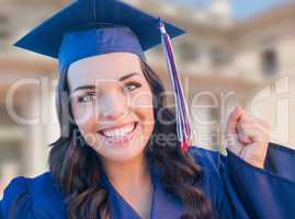 Happy Graduating Mixed Race Woman In Cap and Gown Celebrating on