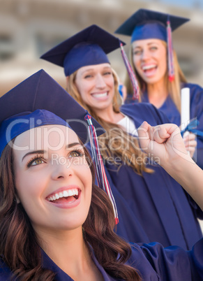 Happy Graduating Group of Girls In Cap and Gown Celebrating on C