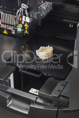 3D Printer With Finished 3D Printed Dental Implant Bridge