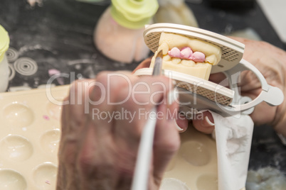 Dental Technician Applying Porcelain To 3D Printed Implant Mold