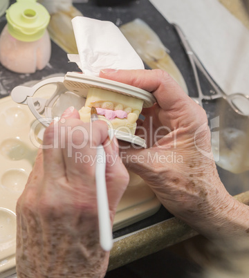 Dental Technician Applying Porcelain To 3D Printed Implant Mold