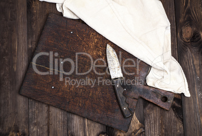 empty old brown wooden kitchen cutting board with a knife