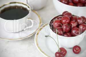 Coffee and cherries in a Cup on the table.