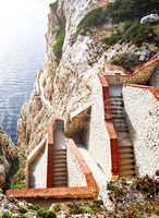 steep staircase built on a mountain overlooking the sea