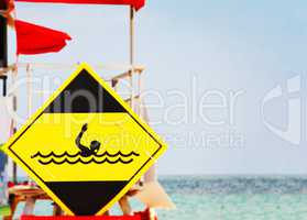 yellow danger signal depicting a drowning swimmer