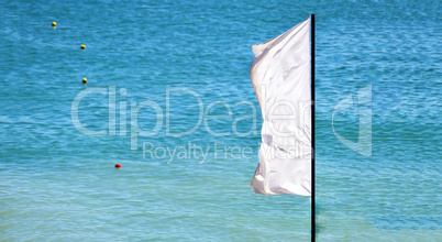 a waving white flag with a blue sea