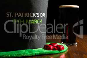 Closeup of St Patrick day with a pint of black beer and hat over
