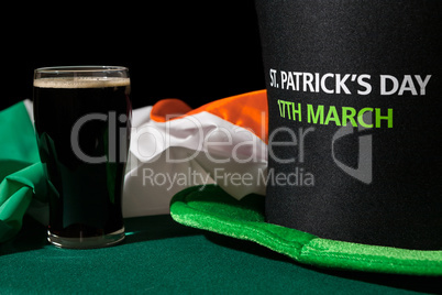 Closeup of St Patrick day with a pint of black beer, hat and iri