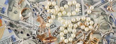 Background of American dollars and jewelry. Flat lay, top view.