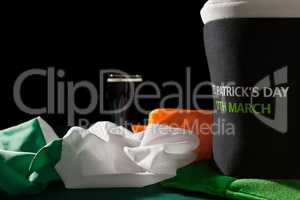 St Patrick day with a pint of black beer, hat and irish flag ove