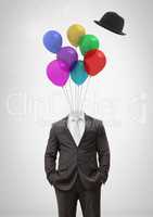 Headless man with surreal floating hat and balloons in front of sky