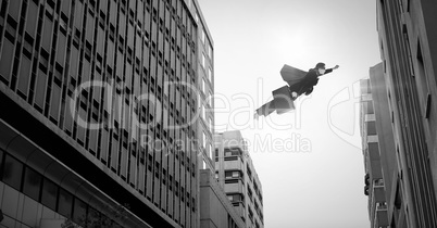 Businesswoman flying over surreal city buildings perspective