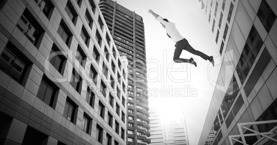 Businessman flying over surreal city buildings perspective