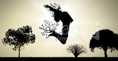 Woman surreal jumping expression with tree branches connected to nature