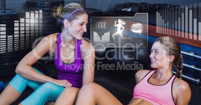 Athletic fit women in gym with health interface