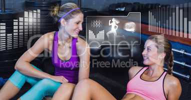 Athletic fit women in gym with health interface