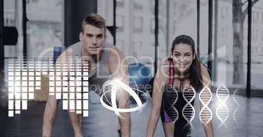 Athletic fit couple in gym with health interface