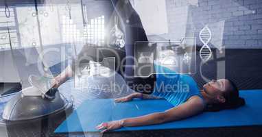 Athletic fit woman in gym with health interface