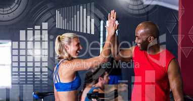 Athletic fit people in gym celebrating goals with health interface