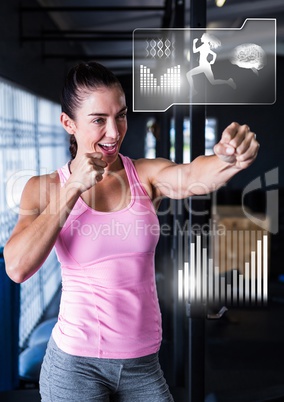 Athletic fit woman in gym with health interface