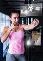 Athletic fit woman in gym with health interface