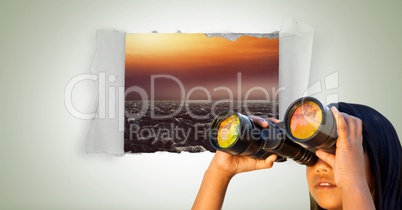 Girl looking through binoculars with sea in paper hole